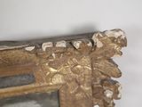 a close up of a mirror with gold paint on it