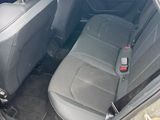 the back seats of a car with a bottle of water in it