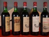 several bottles of wine are lined up on a table