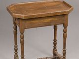 an old wooden table with turned legs and a wooden tray on top