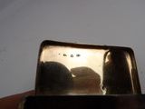 someone is holding a silver plate with a number on it