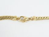 a close up of a gold chain bracelet on a white surface