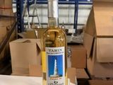 a bottle of wine sitting on a table in a warehouse