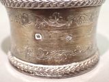 a silver container with a design on it on a table