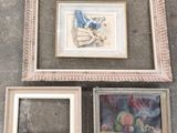 three framed pictures on the ground next to each other