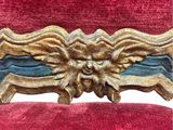 an image of a red chair with a gold lion head on the back