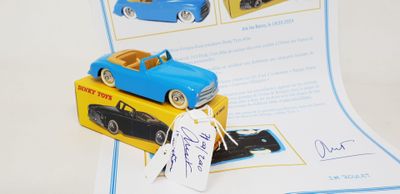 a blue toy car and a yellow toy car on top of a book
