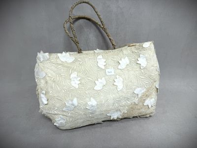 beige and white bag with white flowers on it