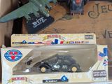 a toy truck and a toy plane in a box