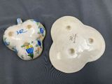 two ceramic heart shaped dishes are sitting on a table
