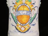 a white vase with a blue and yellow design on it