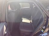 the back seat of a car with the door open in a parking lot
