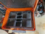 an orange tool box with six compartments inside of it