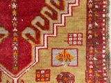 an image of a red and yellow rug on a white surface