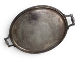 an old metal tray with handles on a white surface