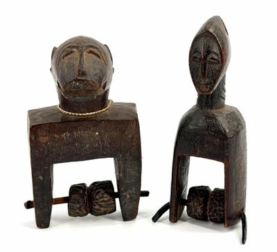 pair of carved wooden figures of a man and a woman