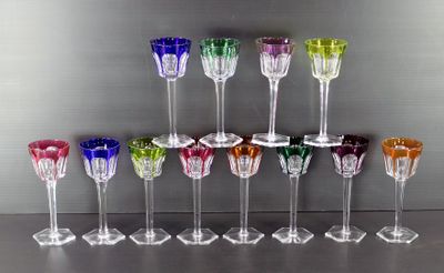 de nombreux verres à vin de différentes couleurs alignés sur une table