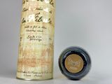 an image of a bottle of ink next to a roll of paper