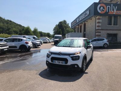 a white car parked in front of a building