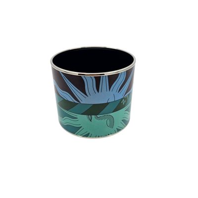 a black cup with a blue and green flower on it