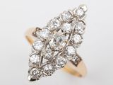 a close up of a diamond ring on a white surface