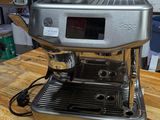 a coffee machine sitting on a wooden table in a room