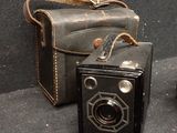 two old cameras sitting next to each other on a table