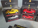 four different models of cars are in boxes on a table