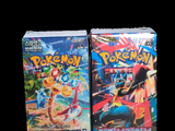 two boxes of pokemon card games on a black background