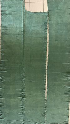 an image of a piece of green fabric being sewn together