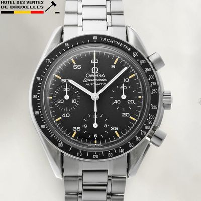 a close up of a watch with a black face and a silver bracelet