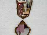 a woman taking a picture of her reflection in a mirror