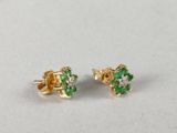 a pair of emerald and diamond stud earrings