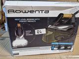 the box of a steam iron is sitting on a cardboard box