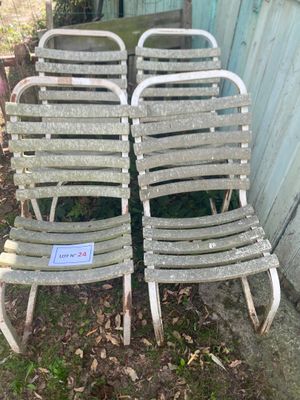 two chairs sitting next to each other on the grass