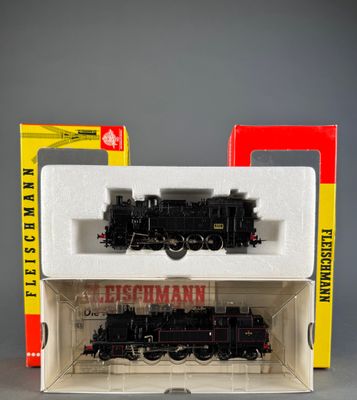 a black and red train in a box next to a red and yellow box