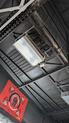 a red sign hanging from the ceiling of a restaurant