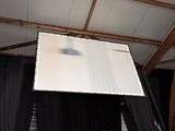 a white screen hanging from the ceiling of a room