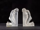 two figurines of a man and a woman sitting on a table