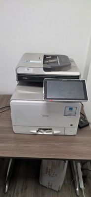 a printer sitting on top of a desk next to a computer