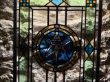 a stained glass window with a compass on it