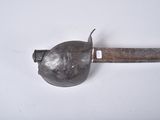 a small metal object with a metal handle on a white surface
