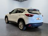the rear end of a white mazda cx - hr parked in a garage