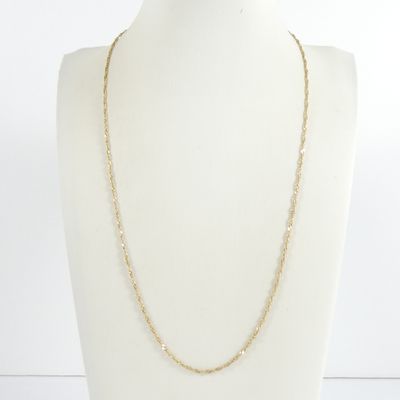 a white mannequin torso with a gold chain on it