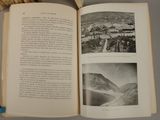 an open book with pictures of mountains in it