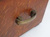 a close up of a wooden box with a handle on it