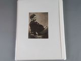a black and white photo of a man sitting in a chair