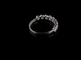 an image of a diamond ring sitting on top of a black surface