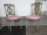 two chairs sitting next to each other on a black and white checkered floor