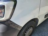 a close up of a car ' s front bumper with a person taking a picture
